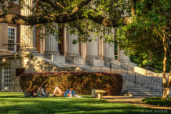 Student study in the shadow of Dallas Hall before finals